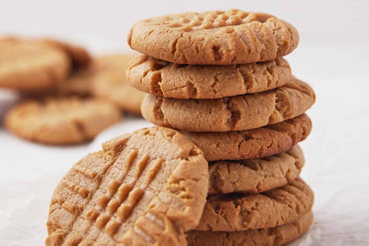 A stack of freezable peanut butter cookies on a white background.