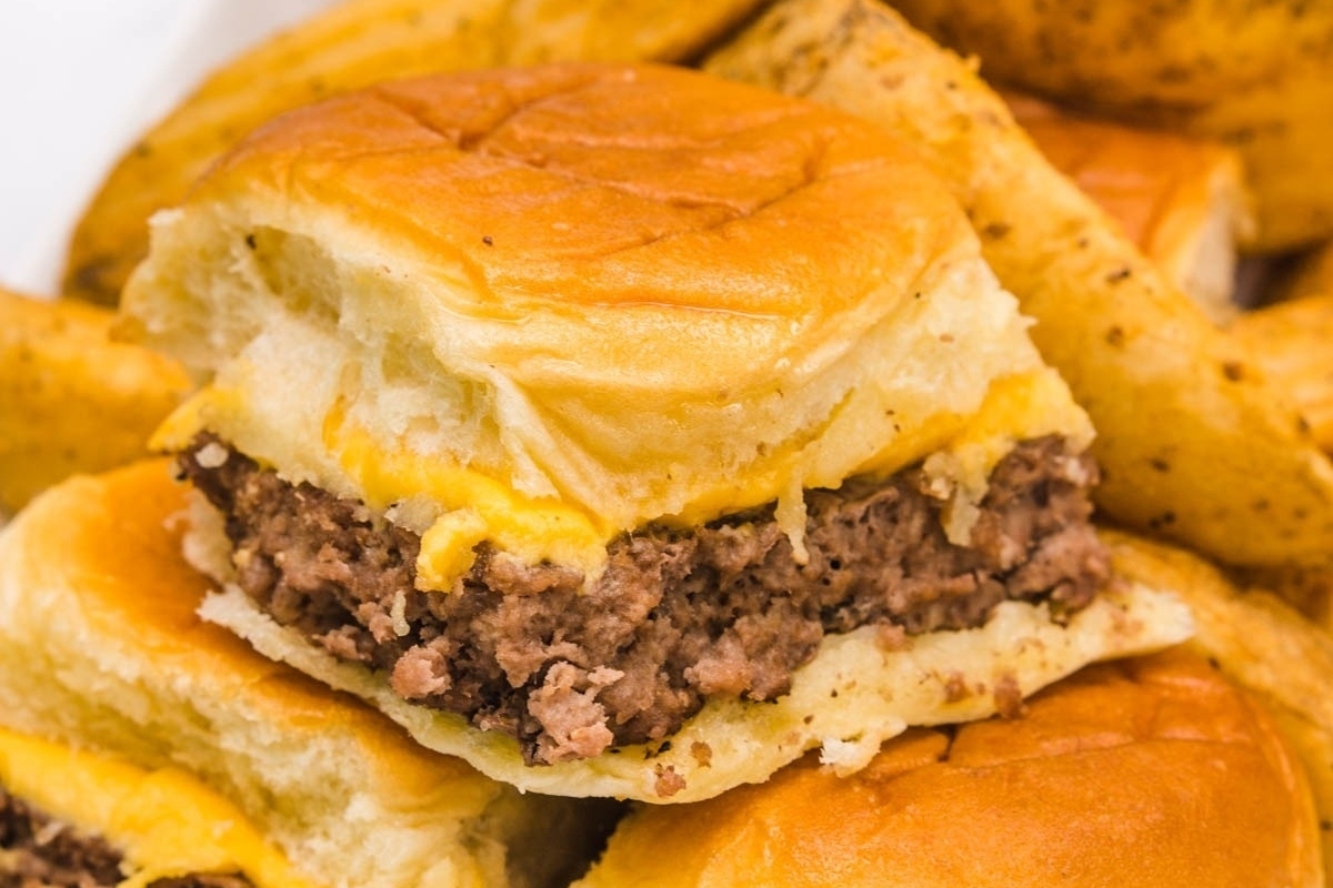 A plate of sliders topped with french fries, perfect for NYE appetizers.