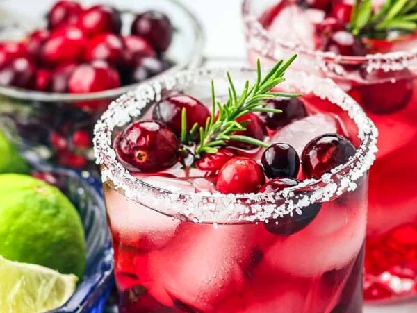A cranberry drink with a garnish.
