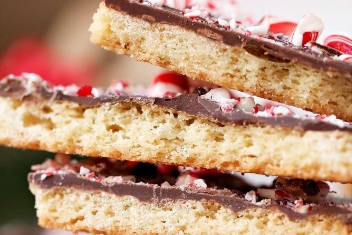 A stack of peppermint candy bars and cookies on a plate.