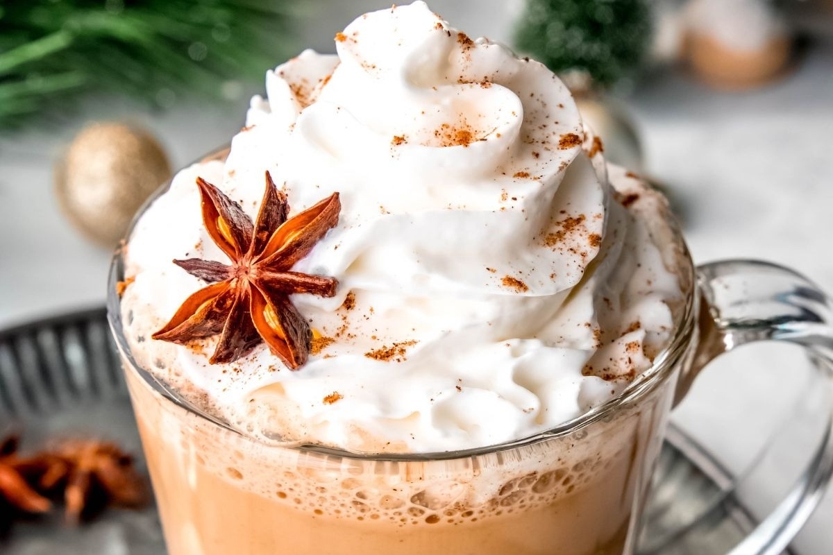 A cup of hot cocoa with whipped cream and star anise, perfect for indulging in winter's favorite warm beverage.
