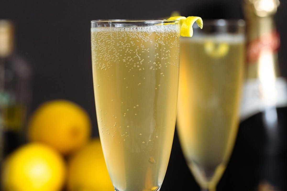 Two glasses of champagne with lemons, perfect for a New Year's Eve cocktail idea.