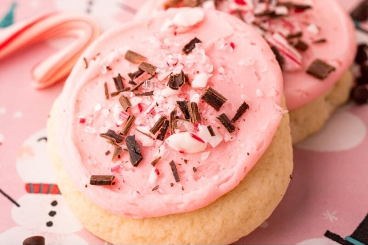 A pink cookie with candy canes.