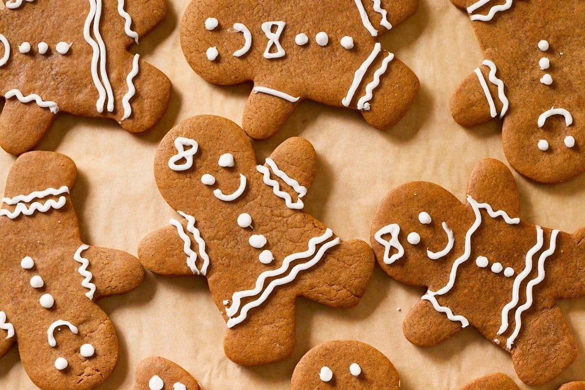 Freezable gingerbread cookies are arranged on a wooden surface.
