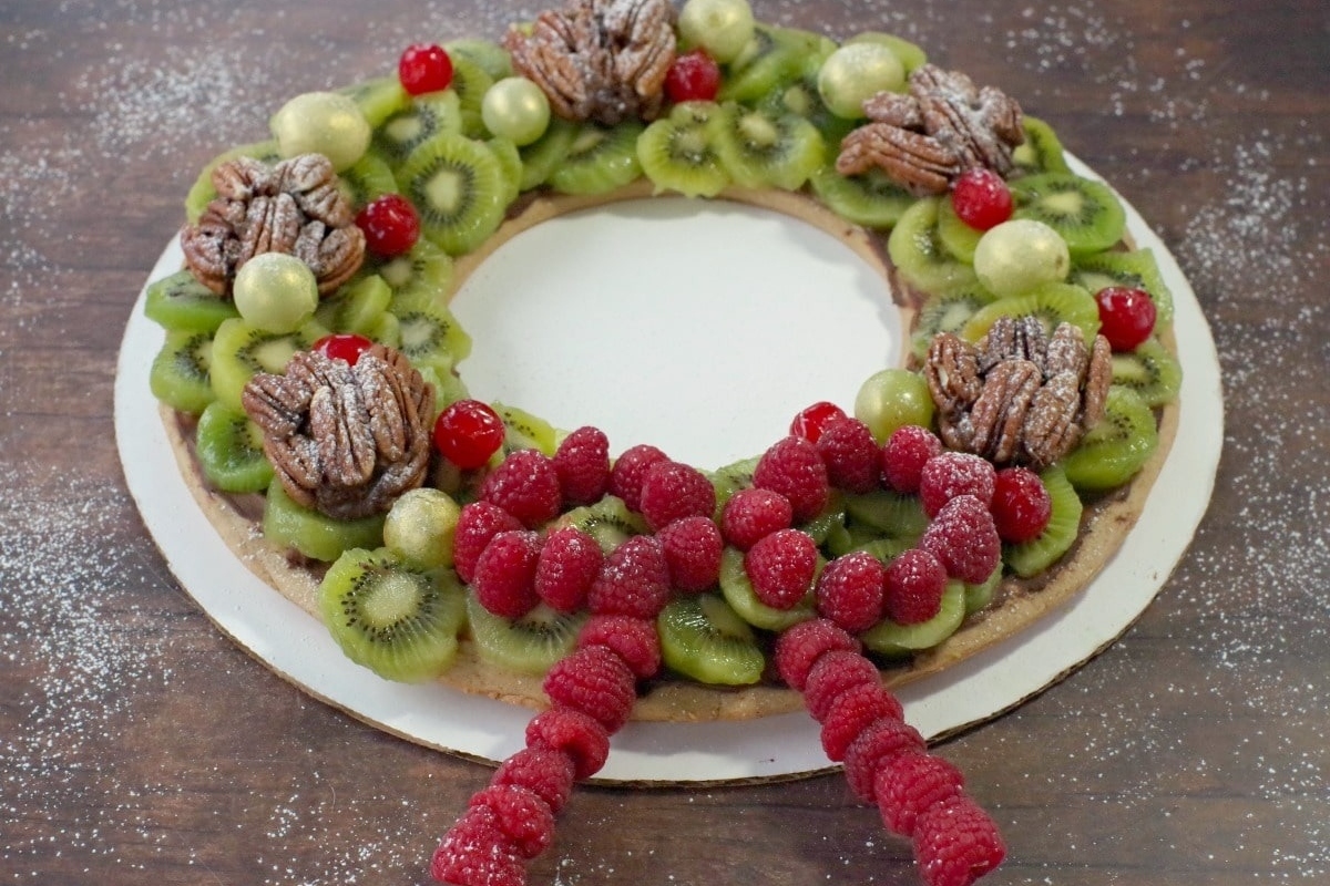 A christmas wreath made of fruit and nuts.