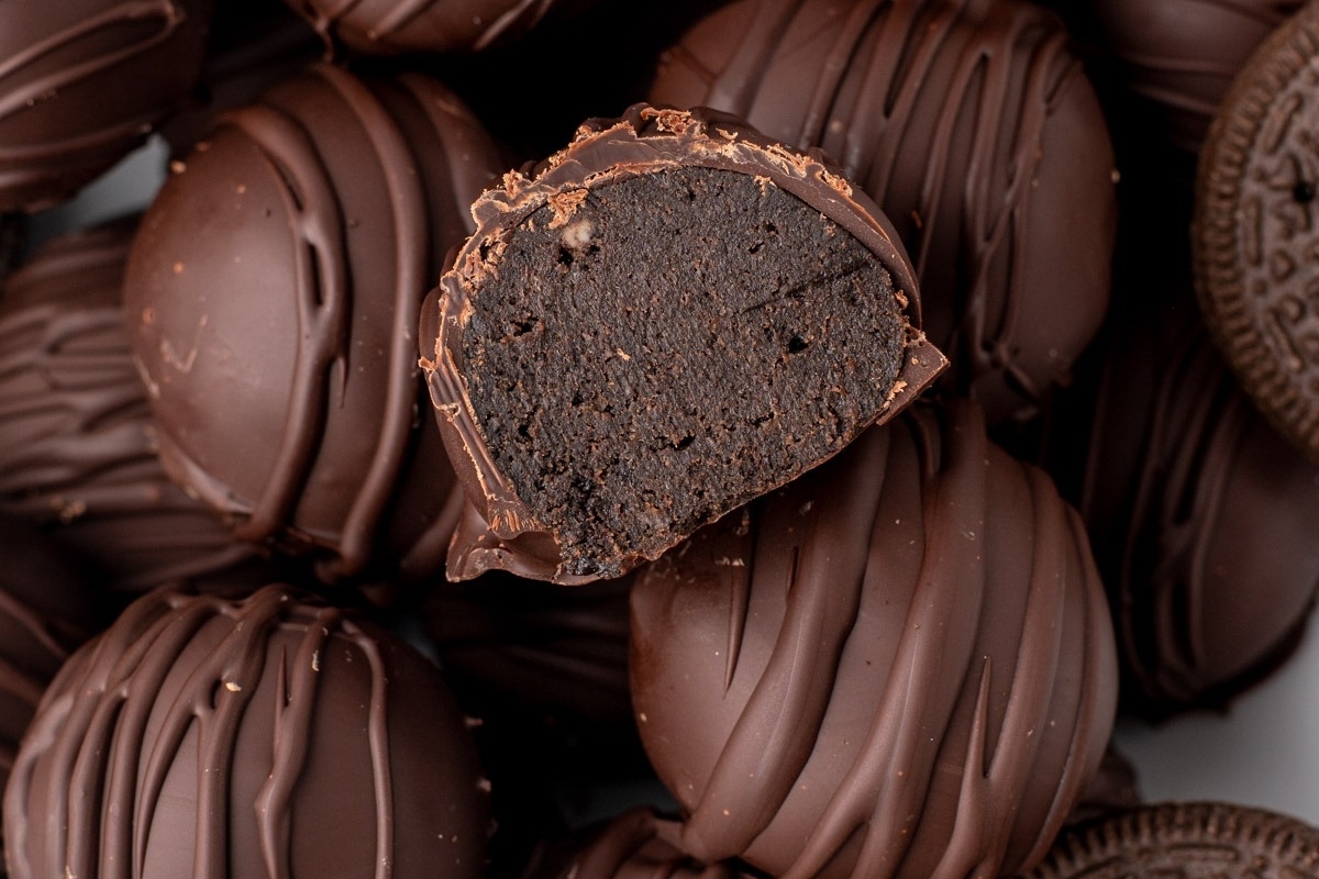 No bake Christmas chocolate oreo truffles with a bite taken out of them.