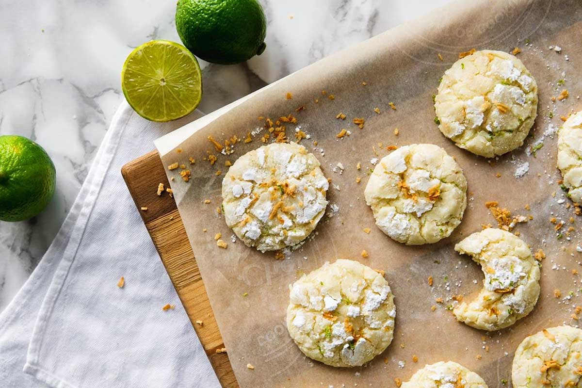 Crinkle coconut lime cookies on a baking sheet.