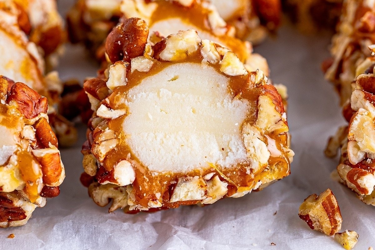 A make-ahead holiday treat, indulge in a plate of creamy ice cream adorned with crunchy nuts and drizzled caramel sauce.