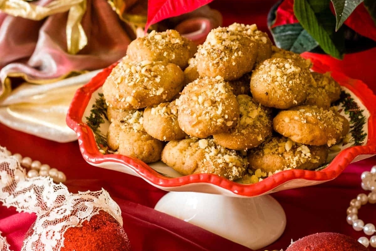 Christmas cookies in a bowl on a red table.