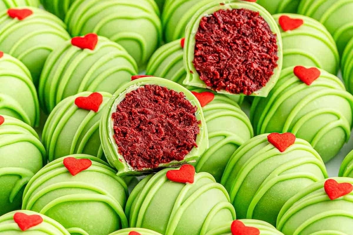 A bunch of green chocolate truffles with red hearts on top, perfect for easy and festive no bake Christmas desserts.