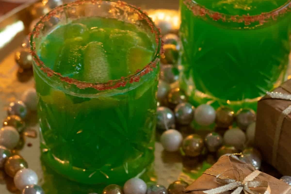 Two glasses of green Christmas drinks on a tray.
