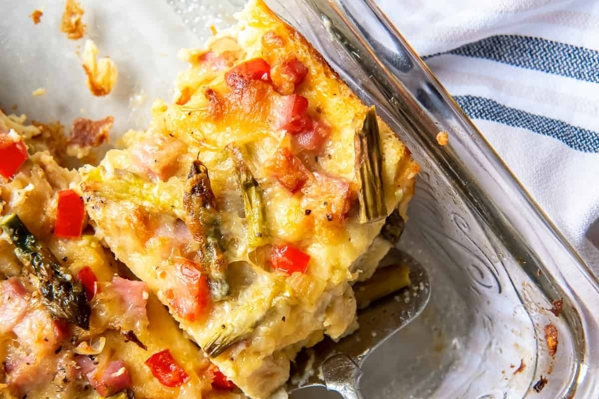 Make-ahead holiday breakfast casserole with ham and peppers in a glass dish.