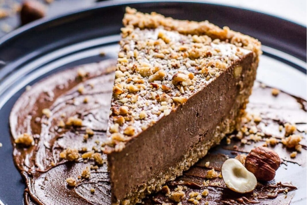 A festive slice of chocolate pie on a black plate, perfect for indulging in one of the best no bake Christmas desserts.