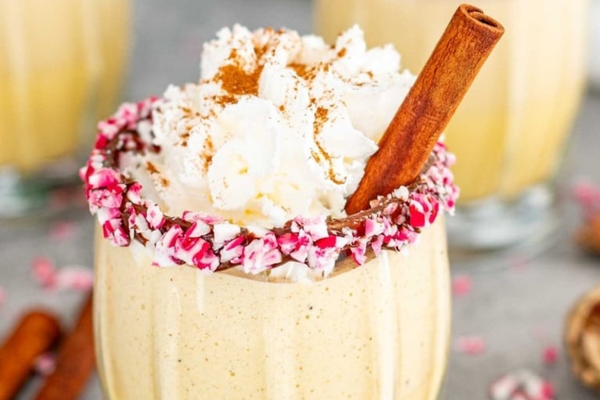 A festive holiday drink, the pumpkin spice latte is beautifully topped with whipped cream and garnished with cinnamon sticks.