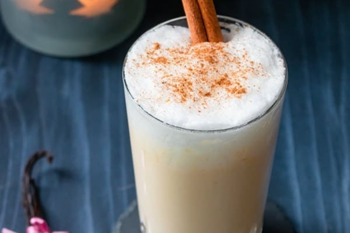 A flavorful eggnog drink with hints of cinnamon and vanilla placed on a table.