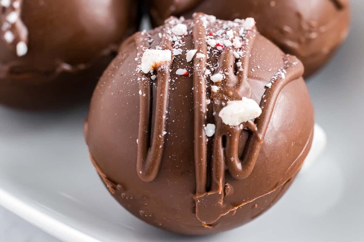        Description: Chocolate covered easter eggs on a white plate.