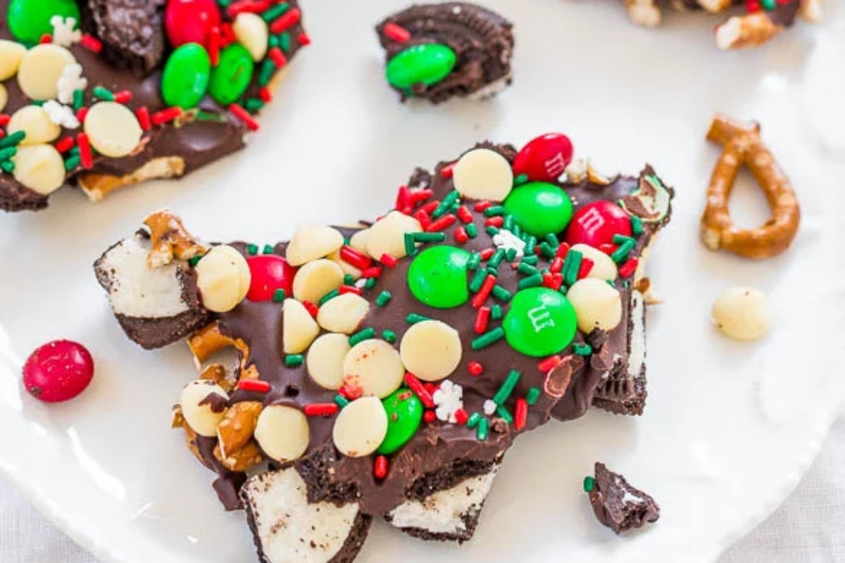 A festive plate of Christmas bark, featuring a delightful combination of candy and pretzels.