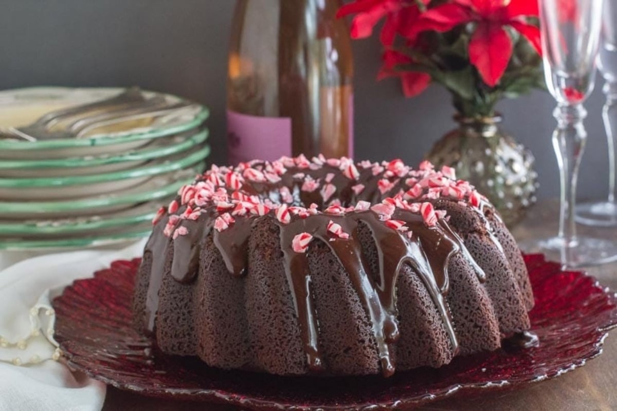 A chocolate bundt cake with peppermint icing on a plate, perfect for peppermint lovers!
