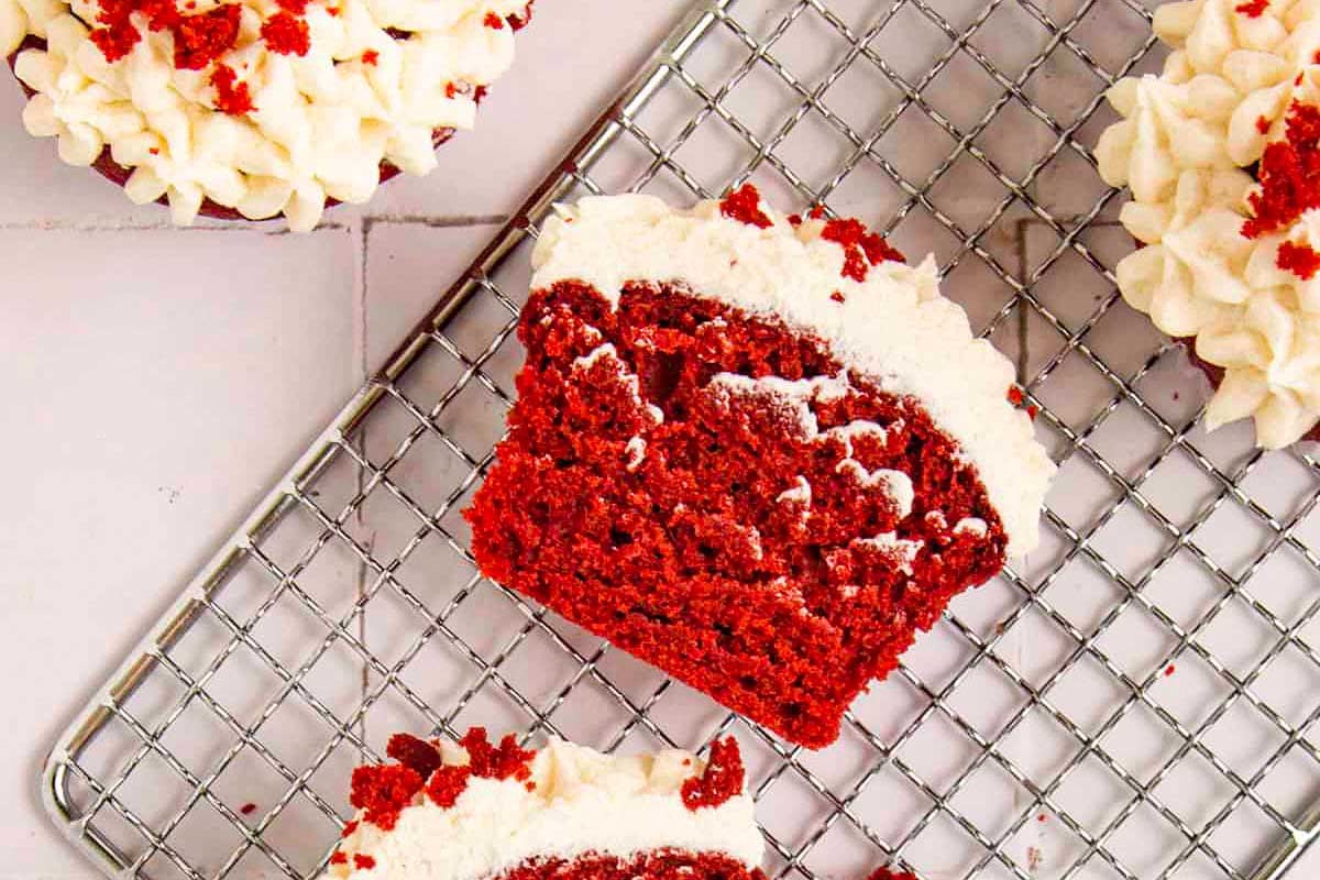 Red velvet cupcakes with a hint of cocoa on a cooling rack.