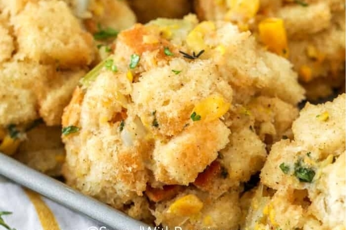 Make ahead cornbread stuffing in a pan with herbs, perfect for holiday dishes.