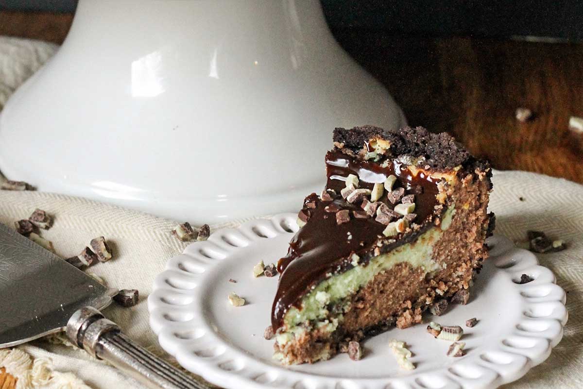 A slice of cocoa mint cheesecake on a plate.
