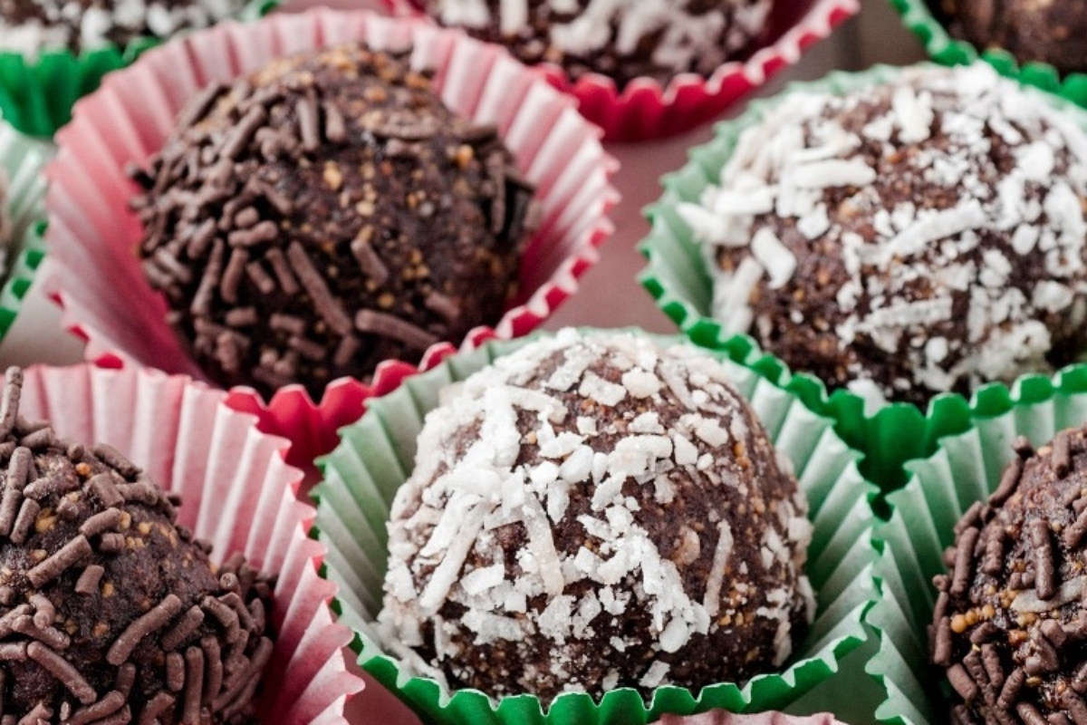 A group of **Christmas** chocolate truffles in green and pink paper cups.
