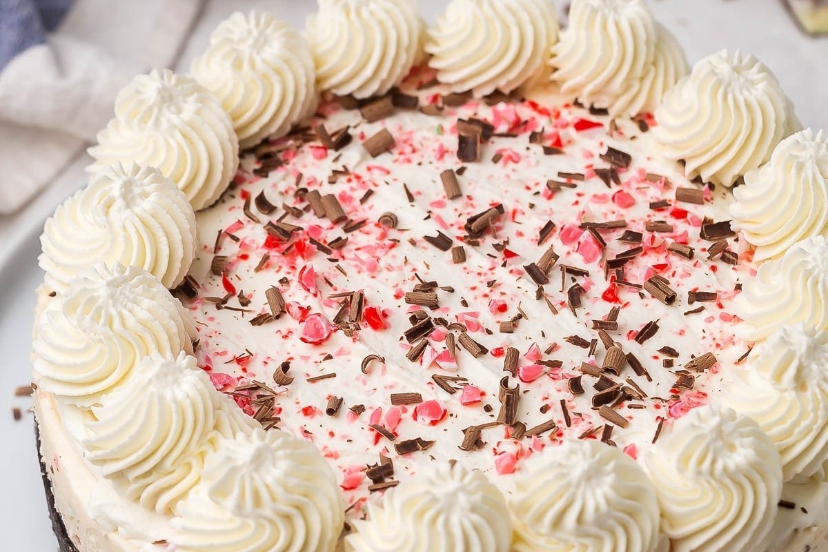 An enticing red and white peppermint cheesecake on a plate, perfect for your holiday festivities.