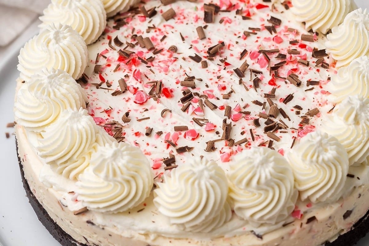 A deliciously festive white chocolate peppermint cheesecake on a plate.