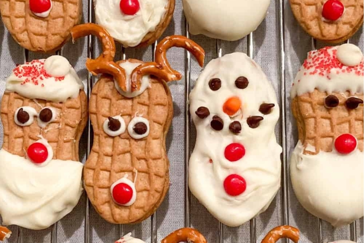 Peanut butter cookies decorated with santa claus and reindeer.