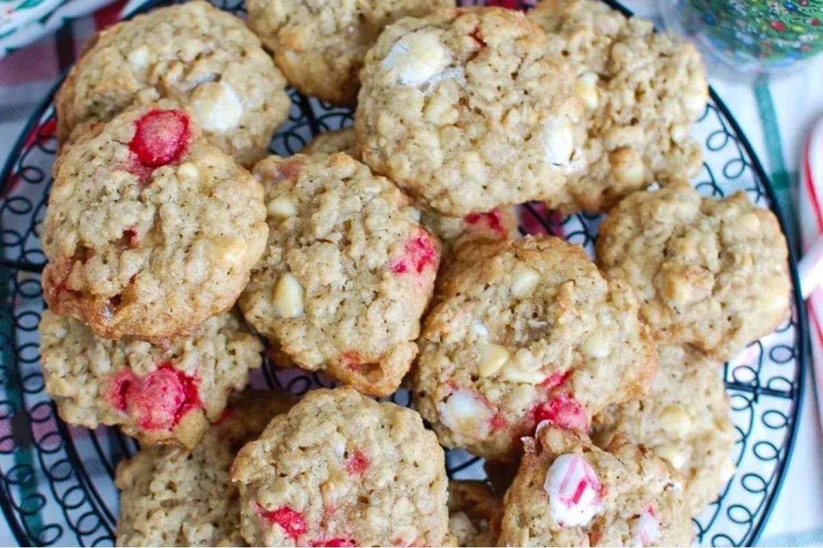 A plate of oatmeal cookies adorned with candy canes.