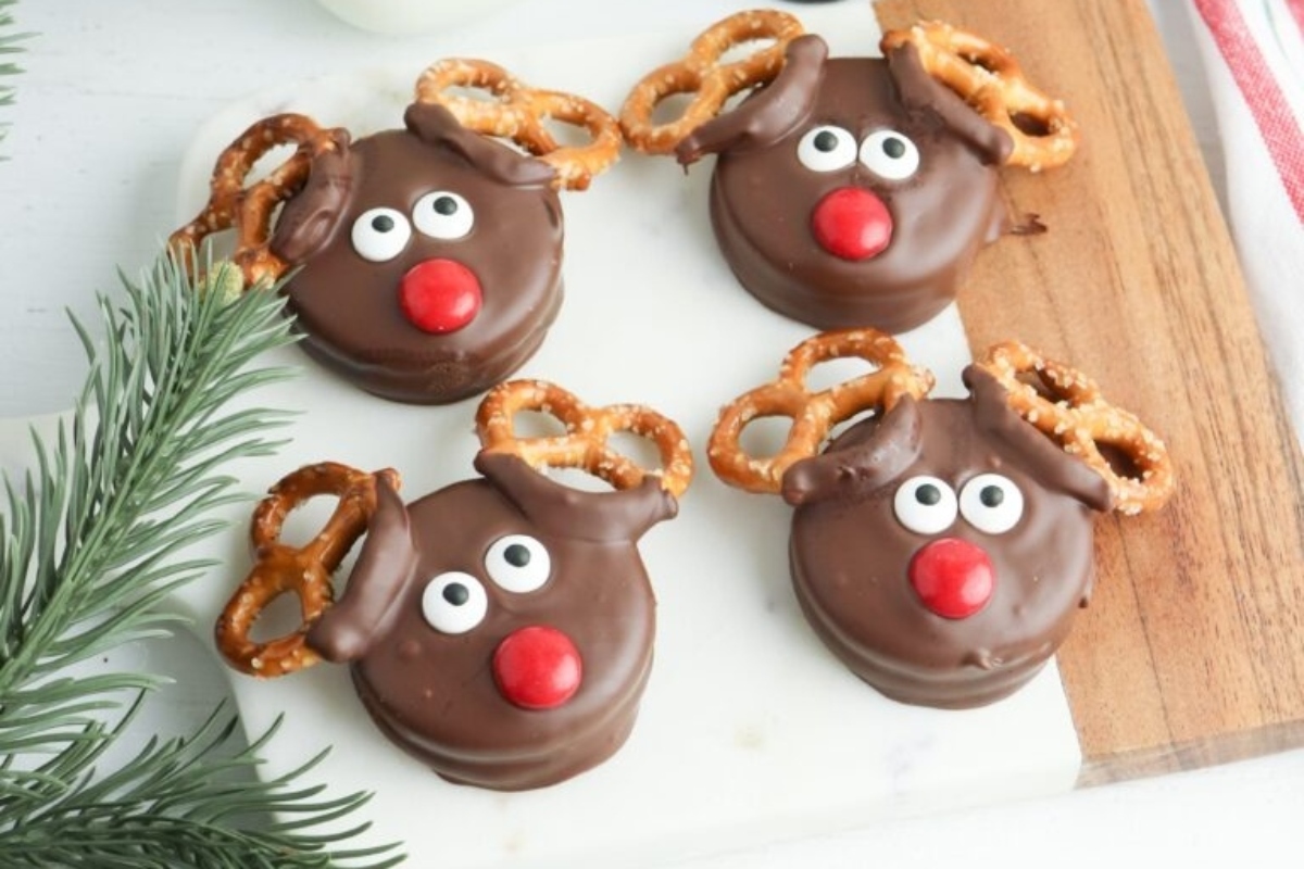 Chocolate reindeer pretzels on a cutting board.