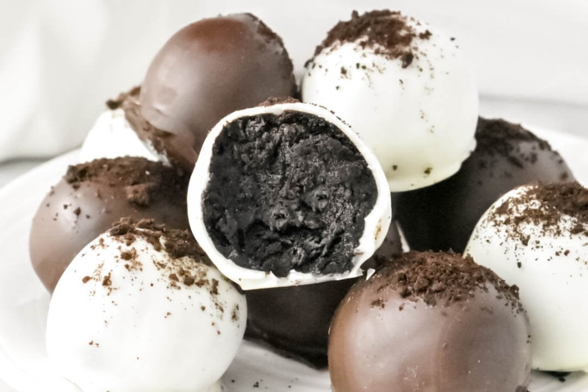 No bake Oreo truffles on a plate with a bite taken out.