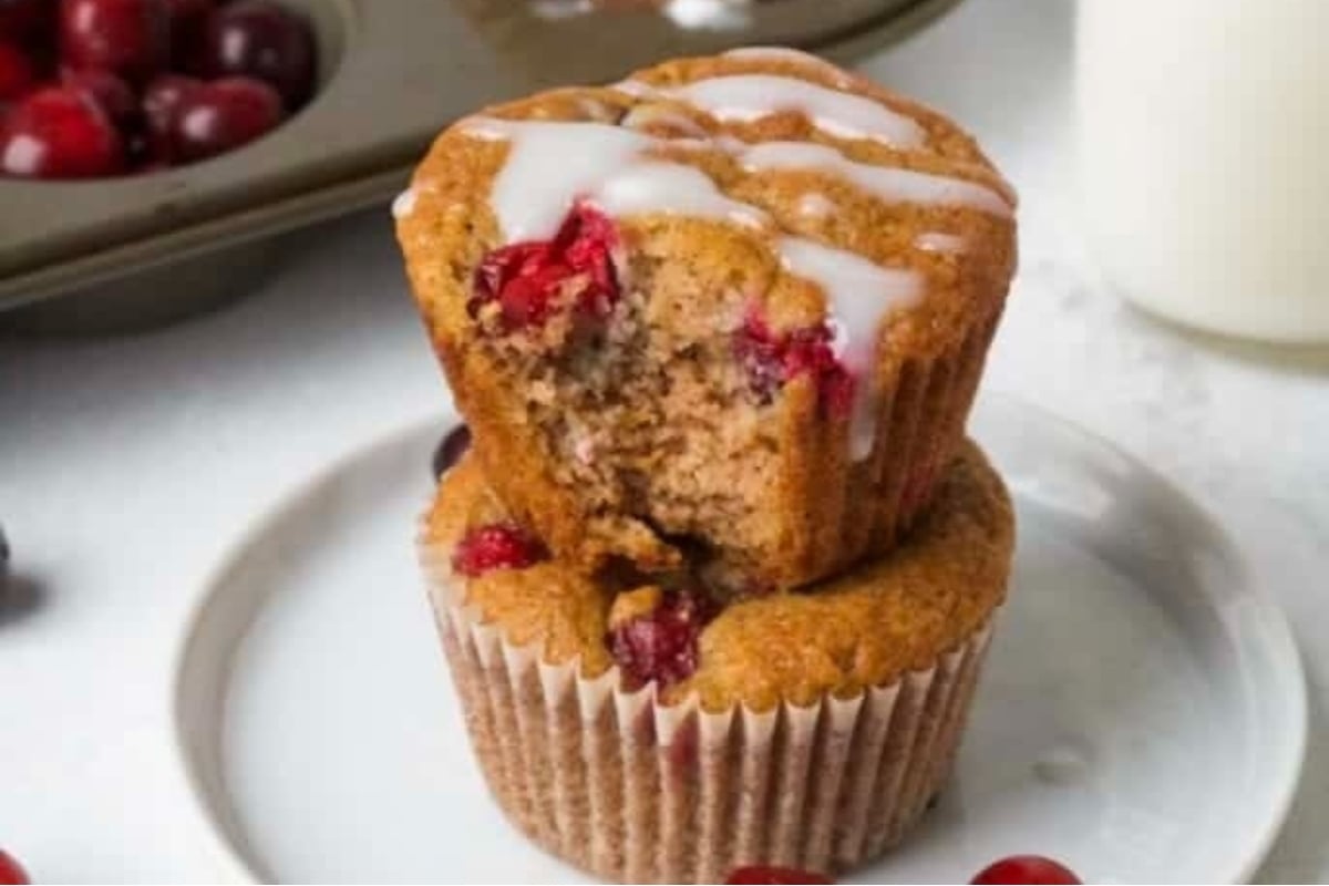 A stack of cranberry muffins on a plate, a delicious cranberry snack.