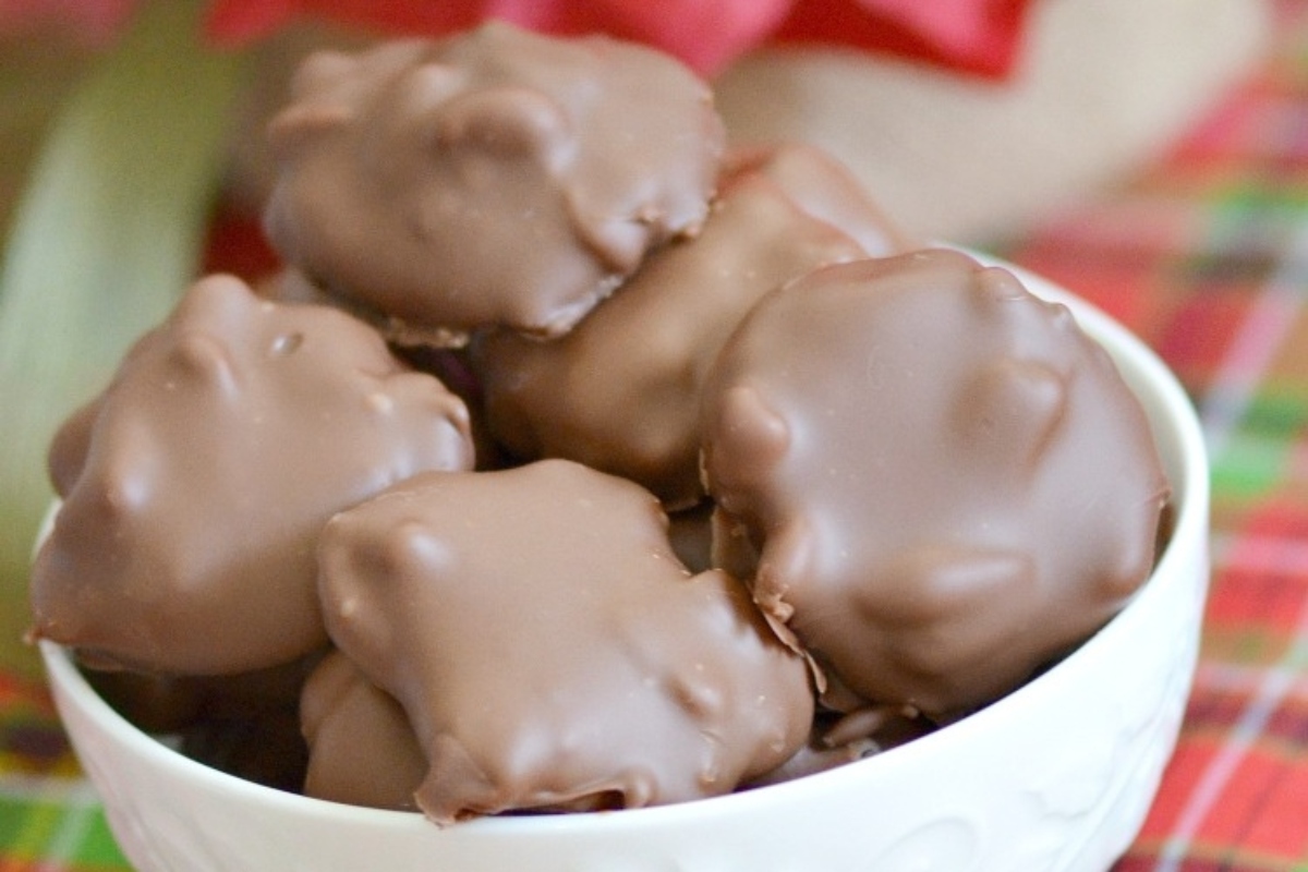 No bake Christmas chocolate covered peanuts in a white bowl.
