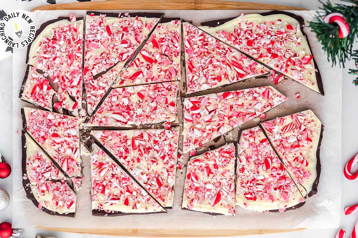 A festive slice of homemade chocolate peppermint bark on a rustic cutting board.