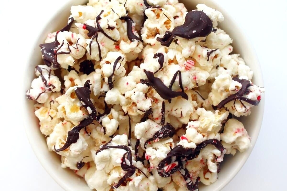 No bake popcorn with chocolate and peppermint drizzle, perfect for Christmas desserts.
