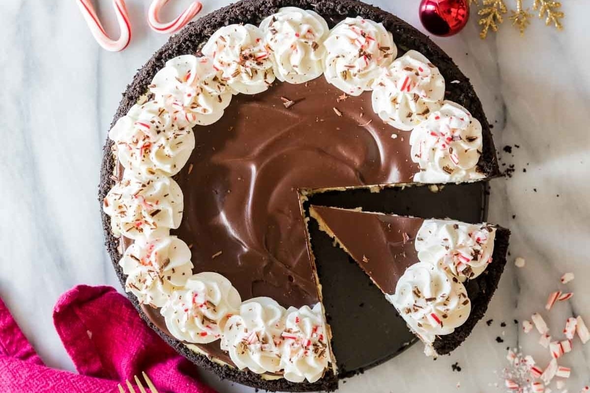 A festive holiday peppermint pie with a slice taken out.