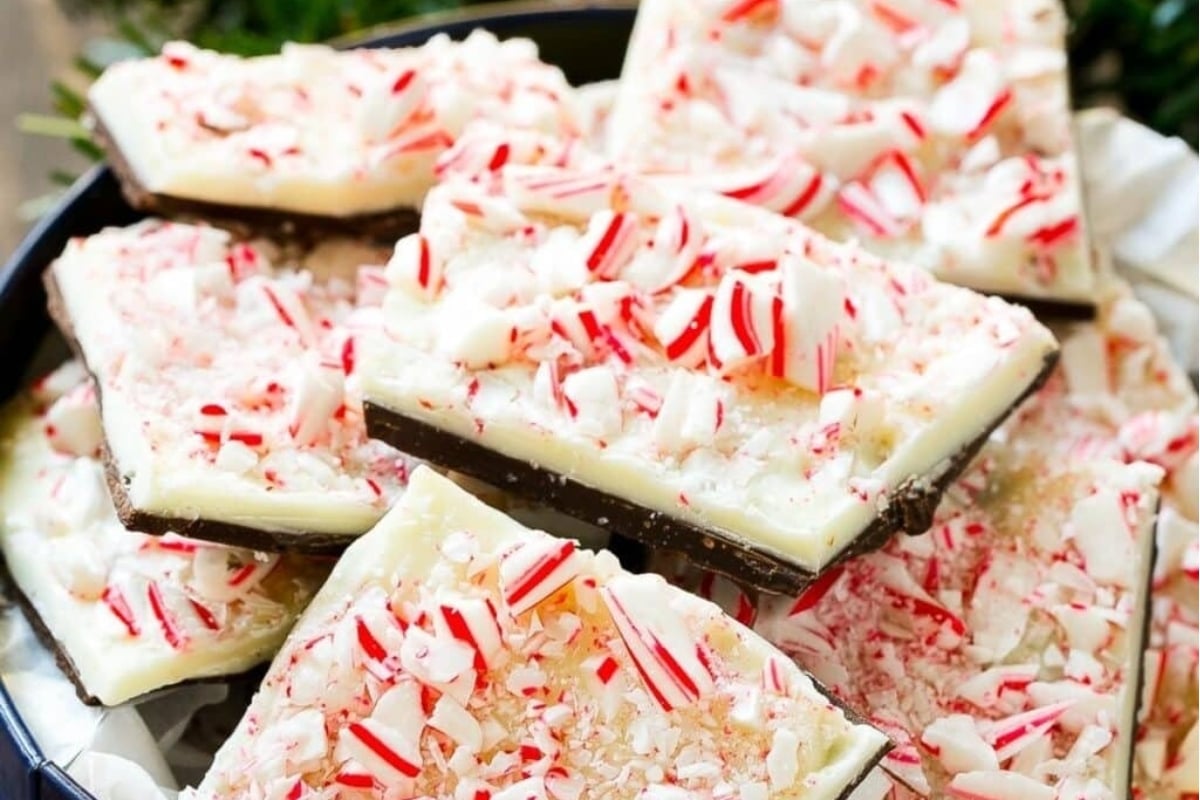 Peppermint bark, a delectable holiday treat, is beautifully presented in a bowl along with candy canes.