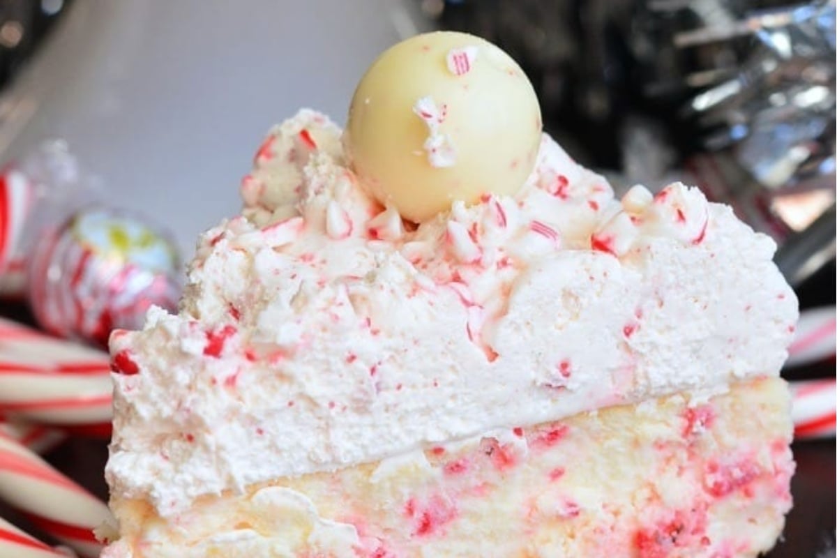 A delectable slice of peppermint cheesecake adorned with candy canes.