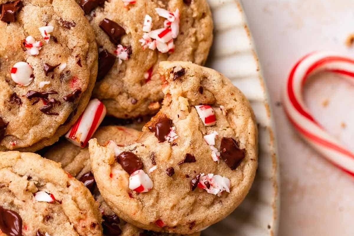 Peppermint chocolate chip cookies on a plate with candy canes.