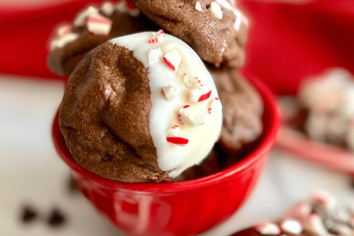 Delicious peppermint cookies arranged in a vibrant red bowl.