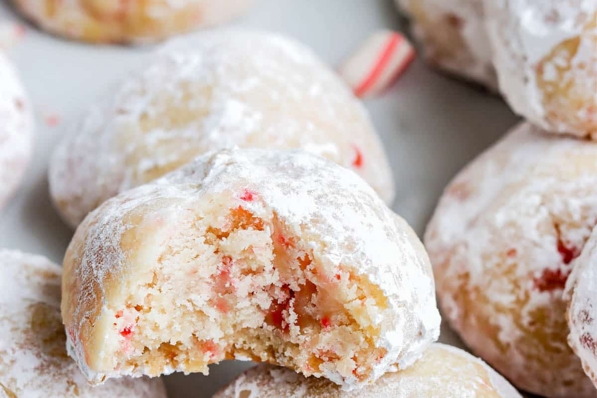 Peppermint candy cane cookies with a bite taken out of them.