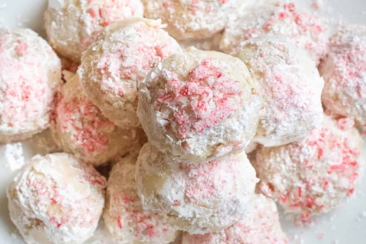 A pile of peppermint sugar cookies on a white plate.