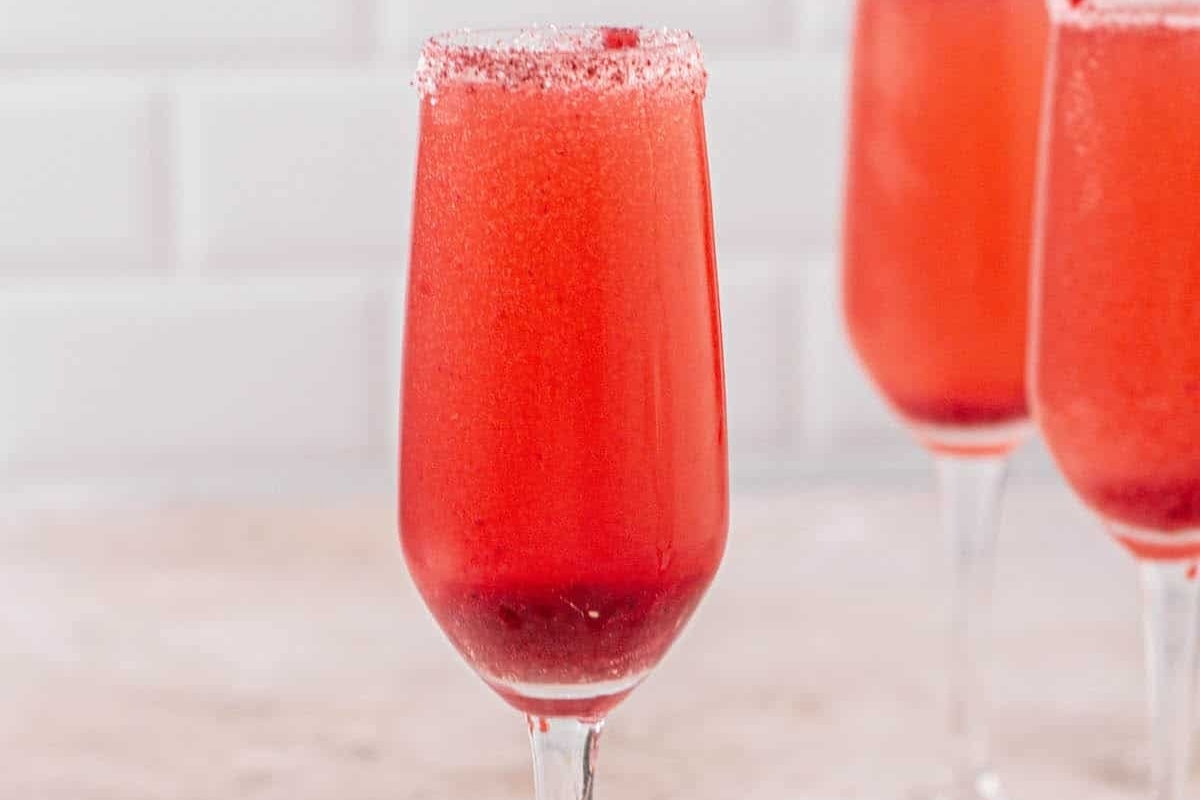 Three glasses with sparkling red liquid in them, perfect for New Year's Eve cocktail ideas.