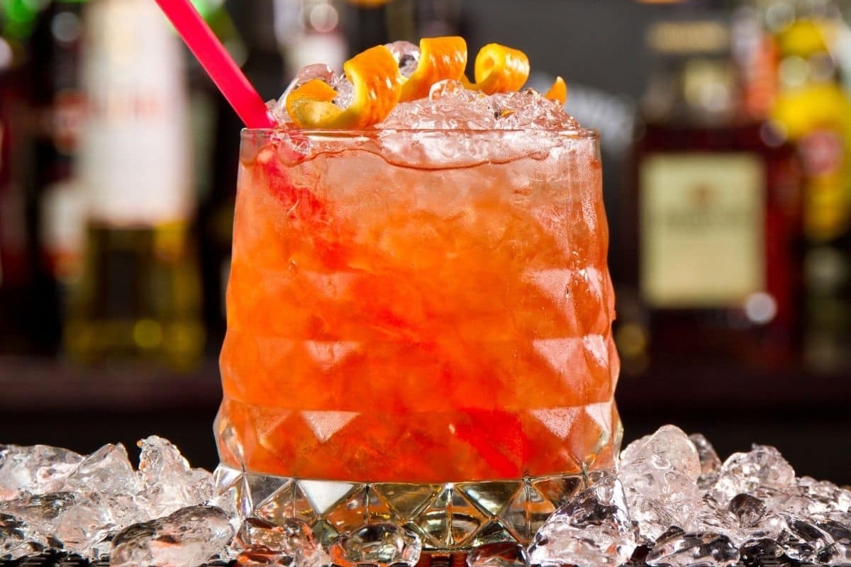 A refreshing New Year's Eve cocktail with orange juice and ice sitting on top of a bar.
