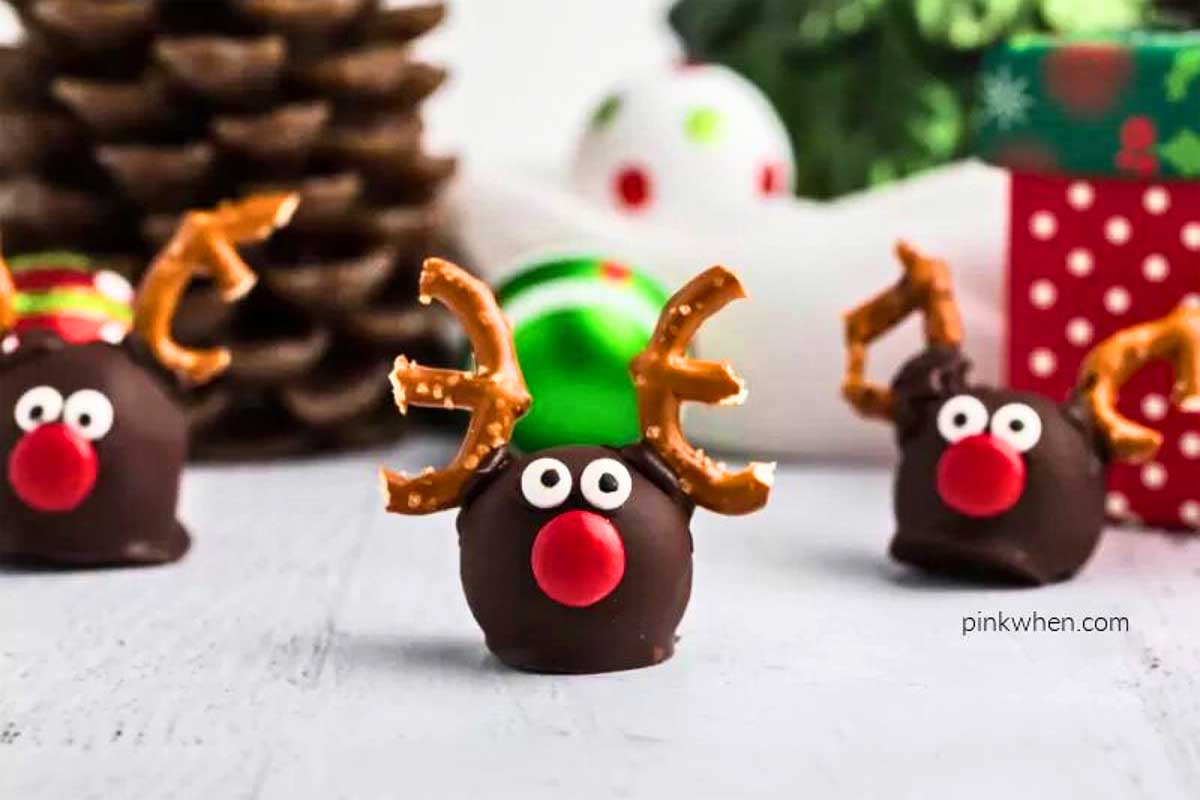 Festive treats featuring chocolate reindeer decorated with pretzels and Christmas ornaments.