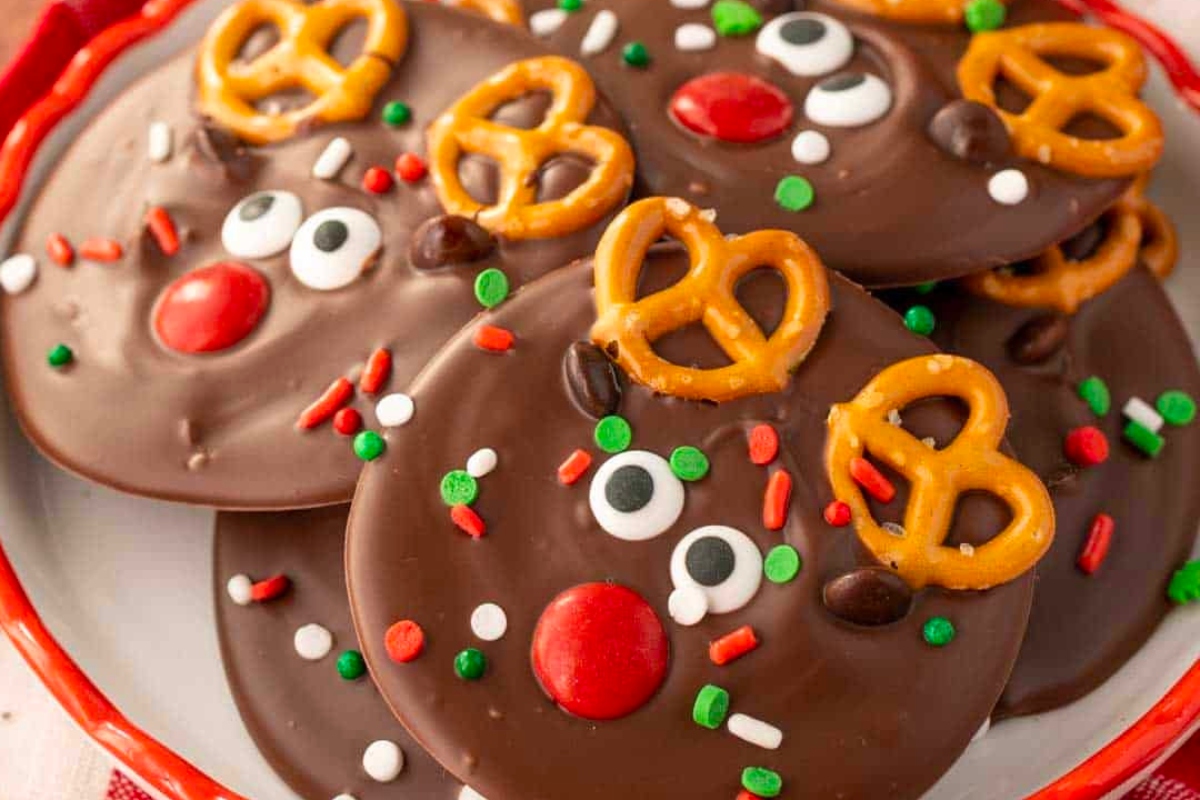 Christmas reindeer cookies with pretzels on a plate.