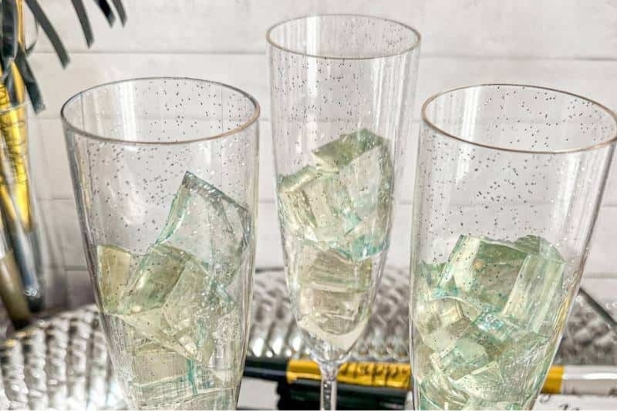 Three champagne flutes filled with ice, perfect for New Year's Eve cocktail ideas.