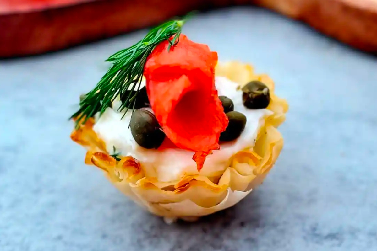 A small cup with cream and a sprig of dill, perfect for your New Year's Eve party appetizers.