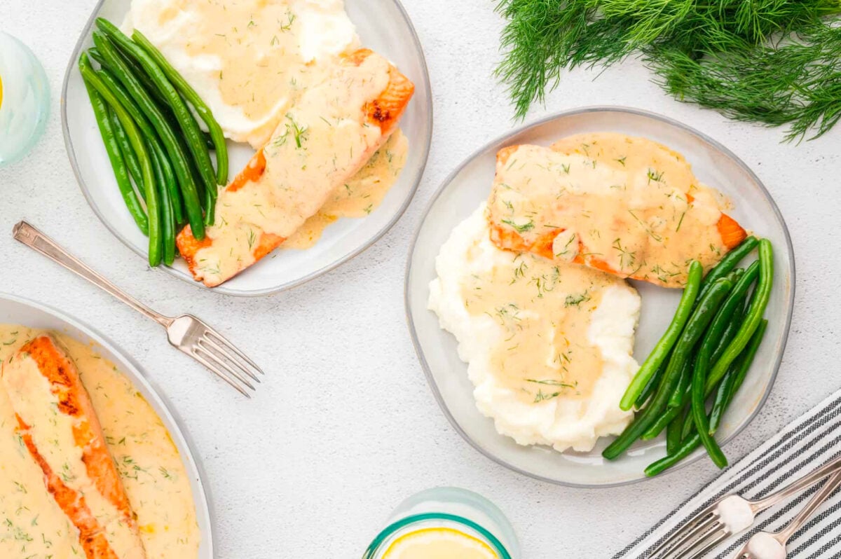 A festive plate with salmon, green beans, and mashed potatoes for New Year's dinners.